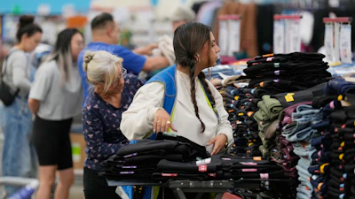 A worker stocks a display of clothing at a Sam's Club, Sept. 24, 2025, Bentonville, Ark.