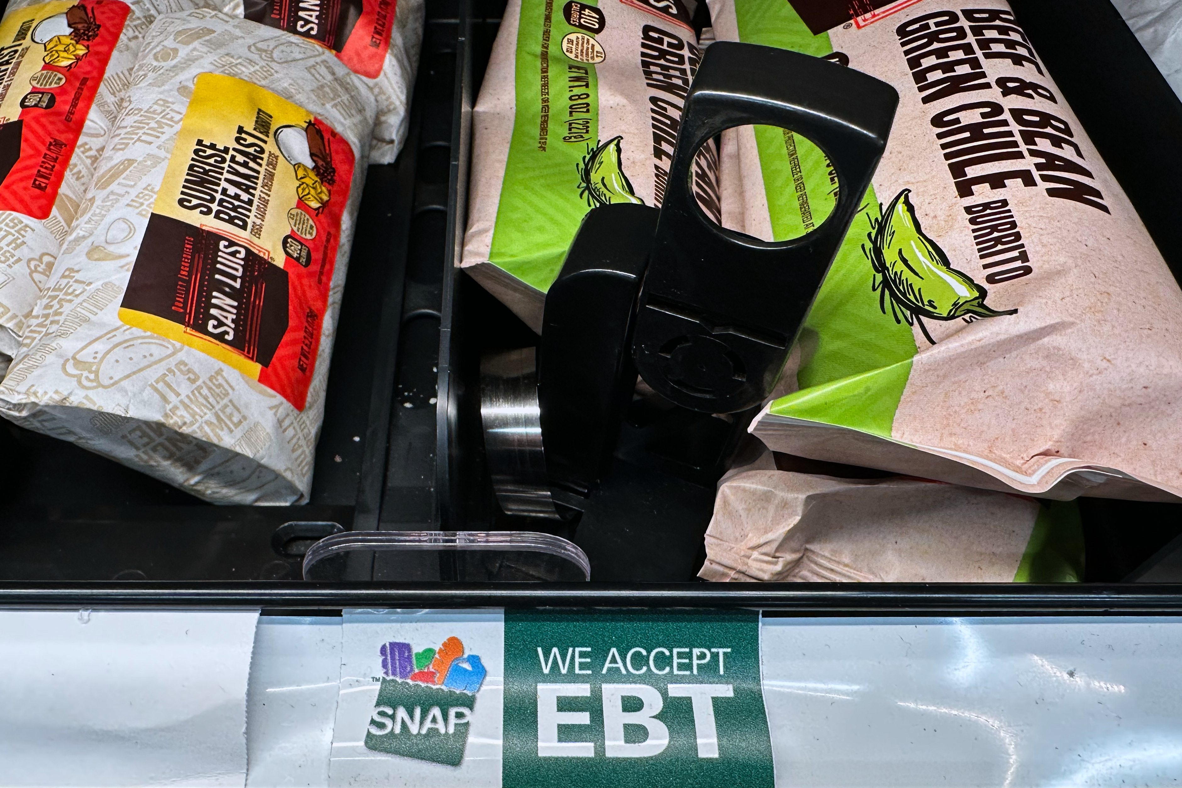 A SNAP EBT sign is displayed on a shelf at a gas station in Riverwoods, Ill., Nov. 1, 2025.