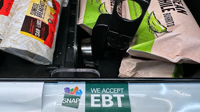 A SNAP EBT sign is displayed on a shelf at a gas station in Riverwoods, Ill., Nov. 1, 2025.