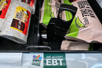 A SNAP EBT sign is displayed on a shelf at a gas station in Riverwoods, Ill., Nov. 1, 2025.