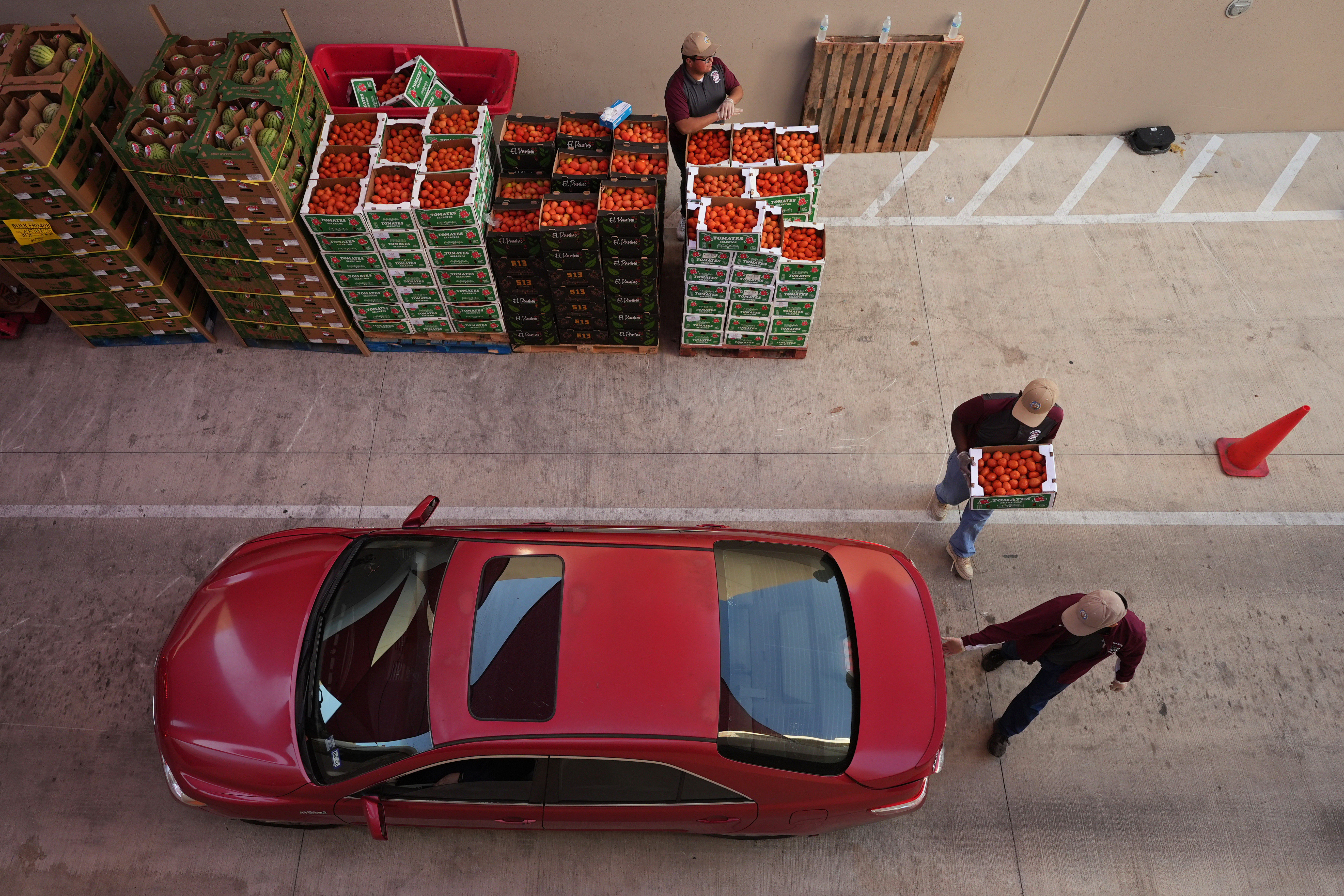 Volunteers help load vehicles during a food distribution at the San Antonio Food Bank for SNAP recipients and other households affected by the federal shutdown, Thursday, Nov. 6, 2025, in San Antonio.