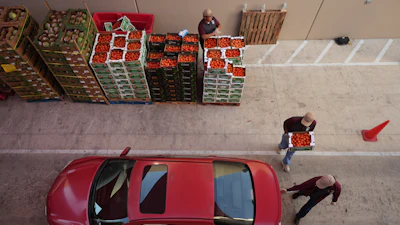 Volunteers help load vehicles during a food distribution at the San Antonio Food Bank for SNAP recipients and other households affected by the federal shutdown, Thursday, Nov. 6, 2025, in San Antonio.