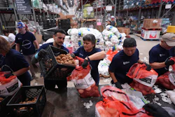 Volunteers at the San Antonio Food Bank load bags of potatoes for a food distribution for SNAP recipients and other households affected by the federal shutdown, Thursday, Nov. 6, 2025, in San Antonio.