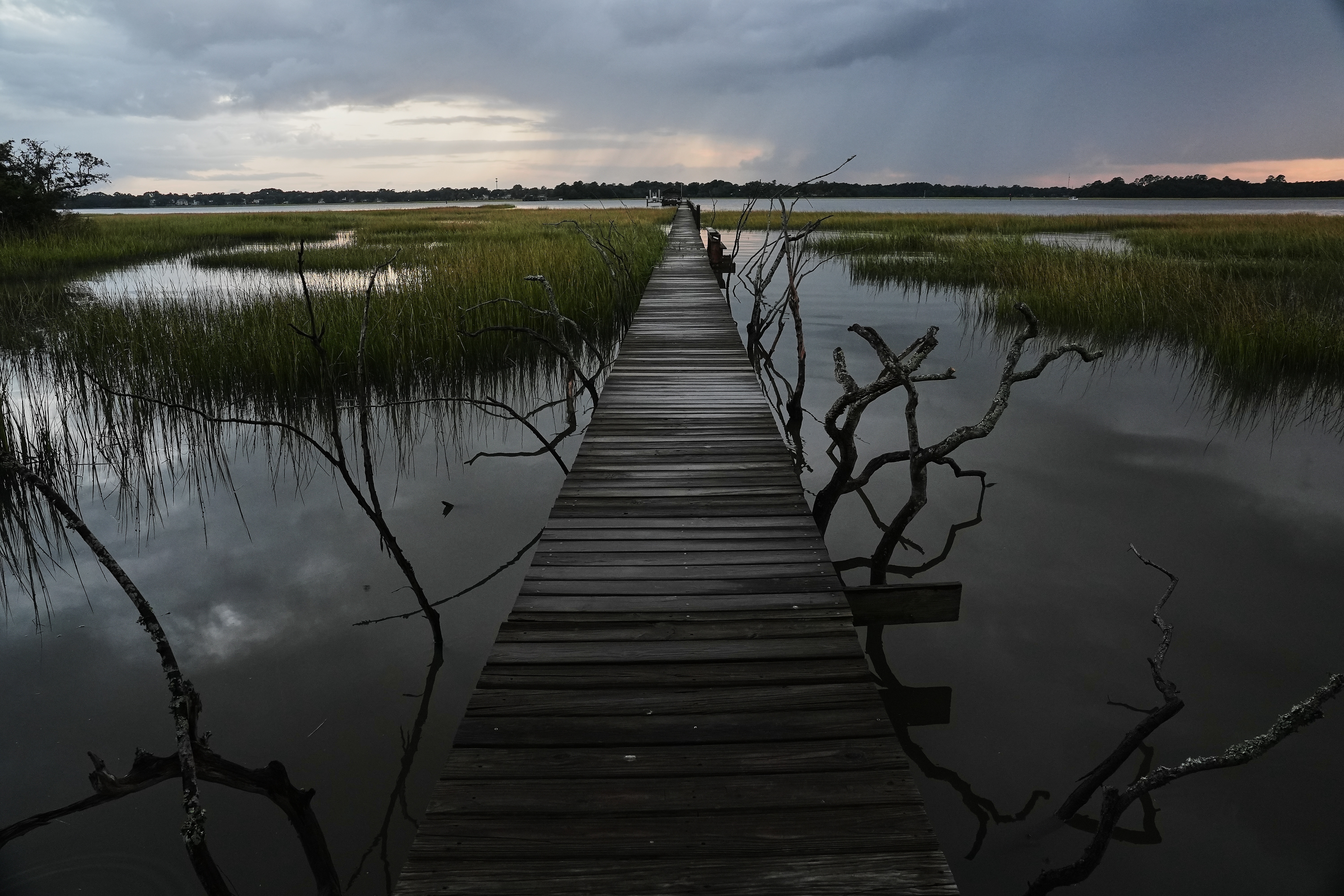 A storm moves through a salt marsh at sunset Monday, Oct. 6, 2025, in Charleston, S.C.