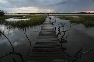 A storm moves through a salt marsh at sunset Monday, Oct. 6, 2025, in Charleston, S.C.