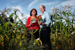 Farmers' Almanac editor Sondra Duncan and publisher Peter Geiger pose in a corn field with the 2012 edition of the almanac, Aug. 24, 2011, in Auburn, Maine.