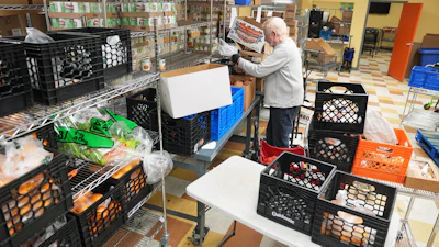 Volunteer Bruce Toben packs groceries durning an emergency food distribution at the at The Jewish Federation of Greater Philadelphia's Mitzvah Food Program in Philadelphia, Friday, Nov. 7, 2025.