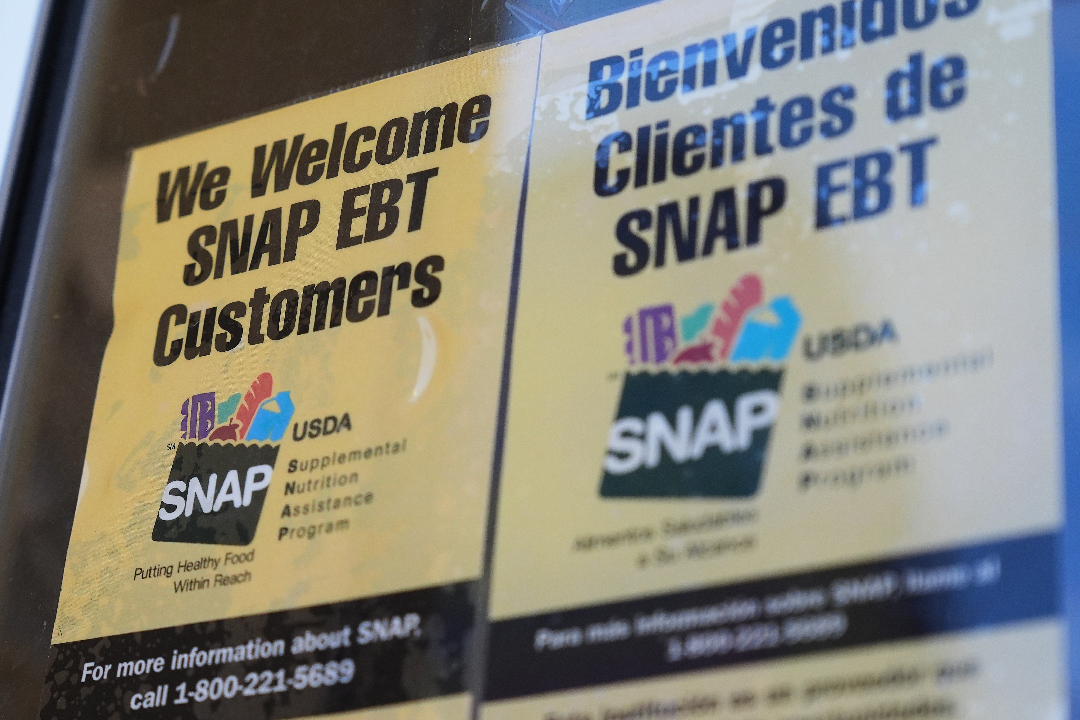 A SNAP EBT information sign is displayed outside of a convenience store in Baltimore, Monday, Nov. 10, 2025.