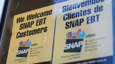 A SNAP EBT information sign is displayed outside of a convenience store in Baltimore, Monday, Nov. 10, 2025.