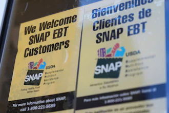 A SNAP EBT information sign is displayed outside of a convenience store in Baltimore, Monday, Nov. 10, 2025.