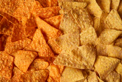 This image provided by PepsiCo shows, from left, original Doritos Nacho cheese chips next to new Doritos without artificial colors or flavors.