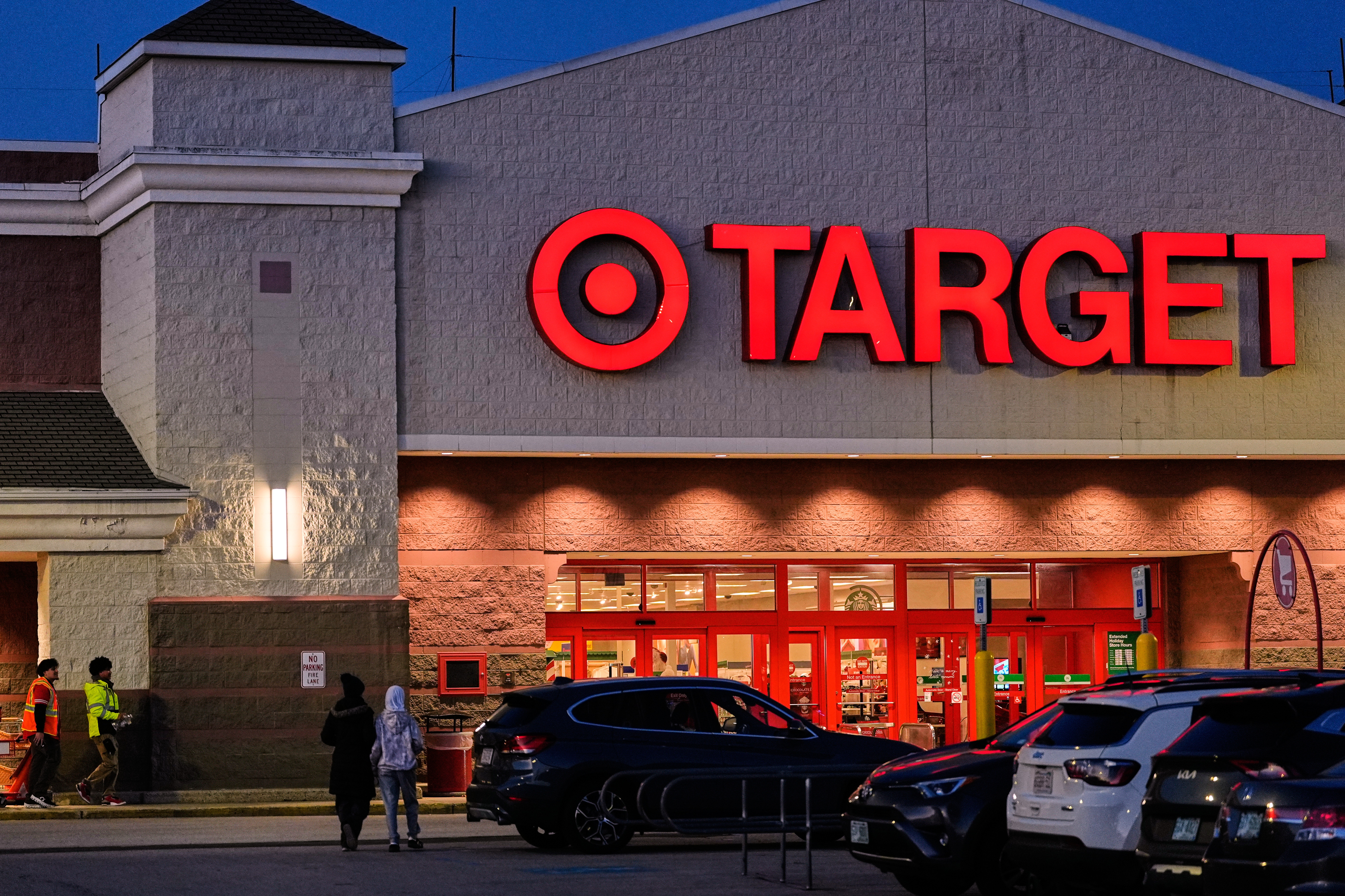 Shoppers walk towards a Target retail store, Tuesday, Nov. 18, 2025, in Salem, N.H.