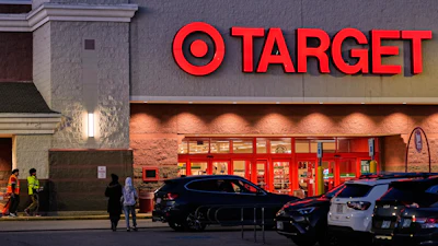 Shoppers walk towards a Target retail store, Tuesday, Nov. 18, 2025, in Salem, N.H.