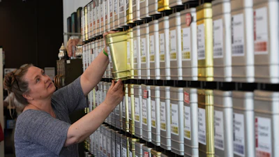 Owner Lisa McDonald packages loose leaf tea orders at the TeaHaus, April 24, 2025, Ann Arbor, Mich.