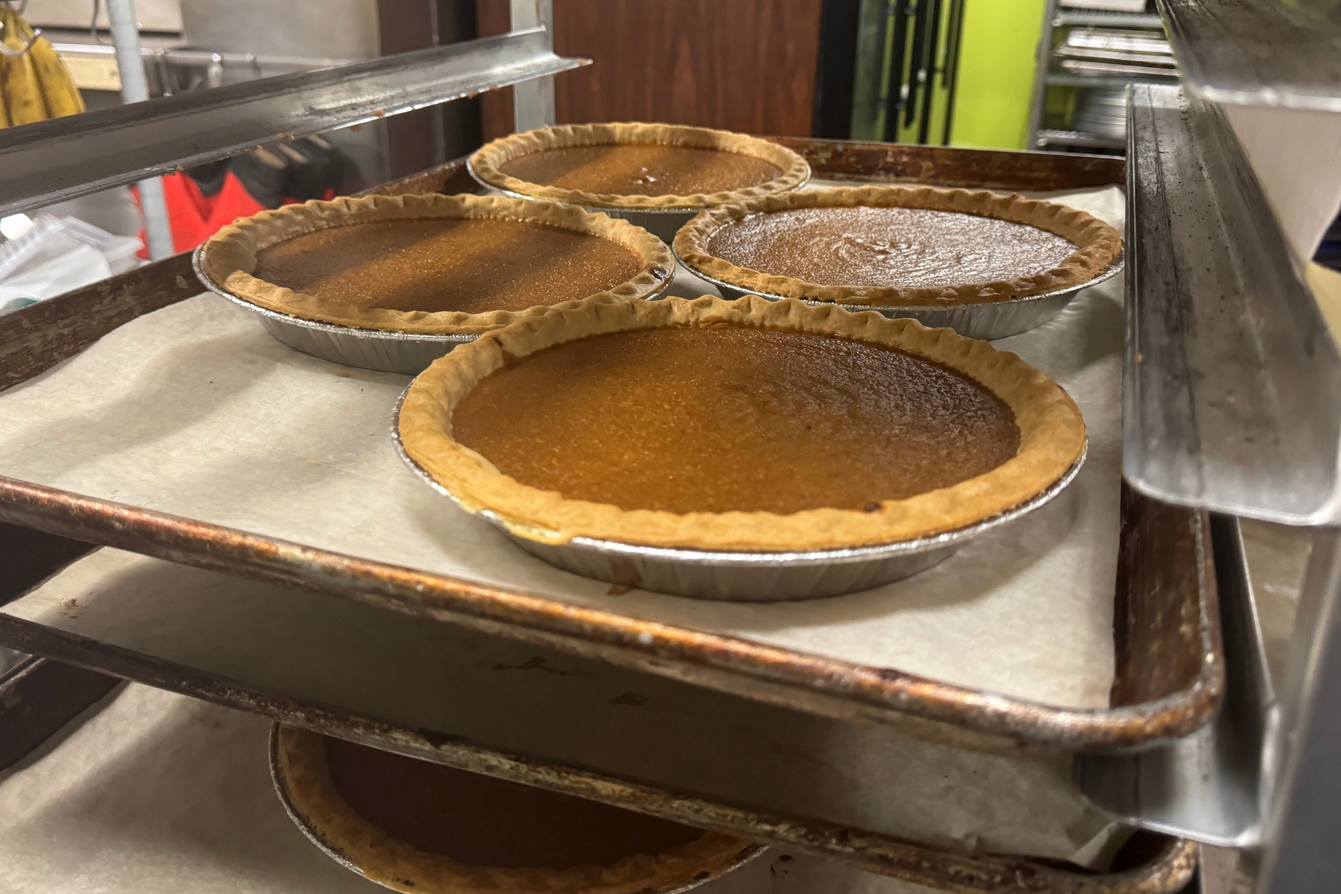 Pies, fresh out of the oven, cool on a baking rack on Friday, Nov. 21, 2025, in Flowood, Miss.