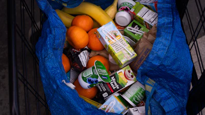 A person stocks their trolley with food from a One Love Community Fridge, Nov. 15, 2025, in Brooklyn, New York.