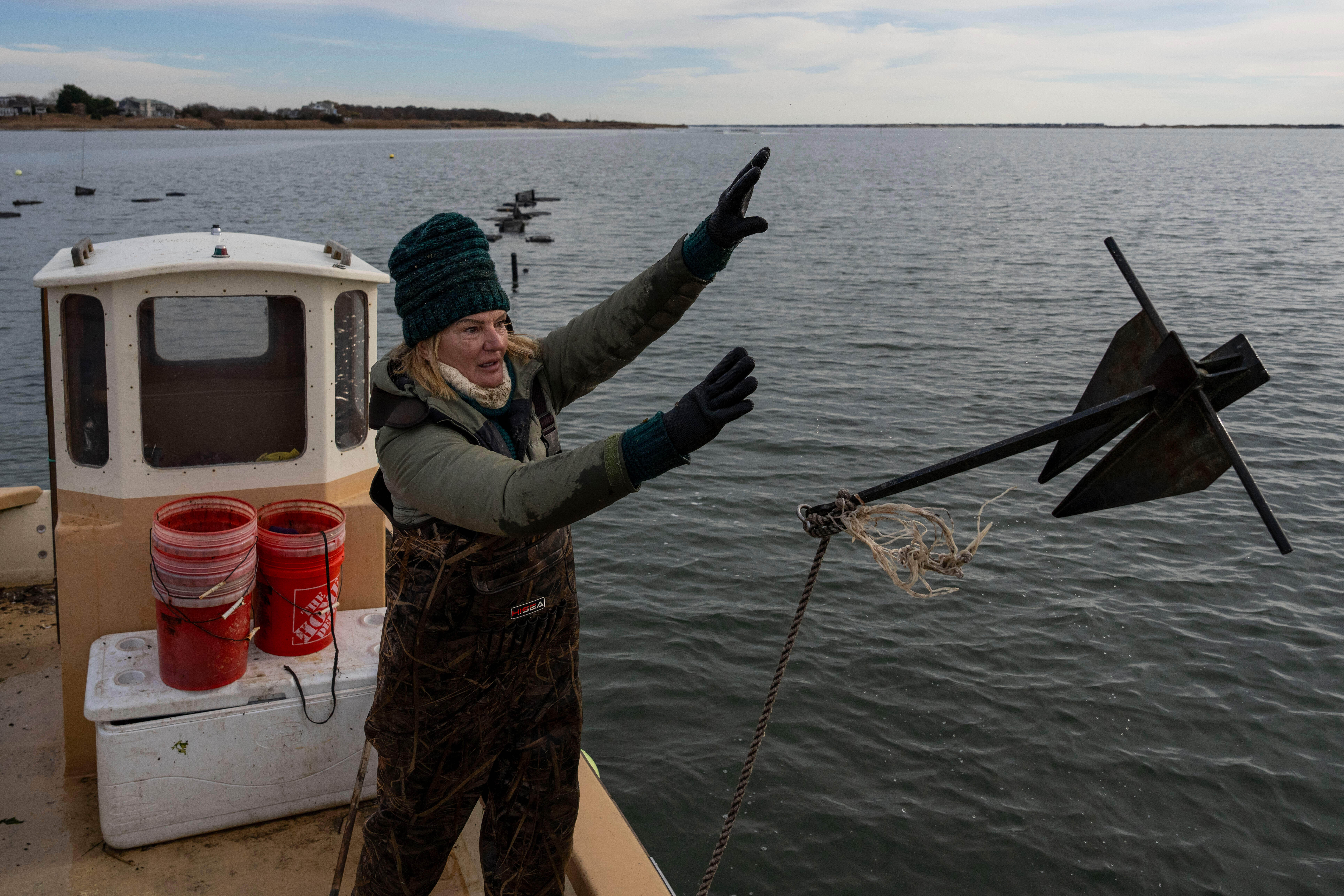 Retired WNBA star and Hall of Famer Sue Wicks throws an anchor from her boat in Moriches Bay in New York, Nov. 20, 2025.