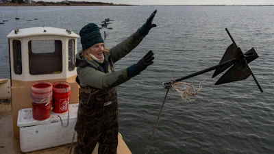 Retired WNBA star and Hall of Famer Sue Wicks throws an anchor from her boat in Moriches Bay in New York, Nov. 20, 2025.