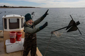 Retired WNBA star and Hall of Famer Sue Wicks throws an anchor from her boat in Moriches Bay in New York, Nov. 20, 2025.