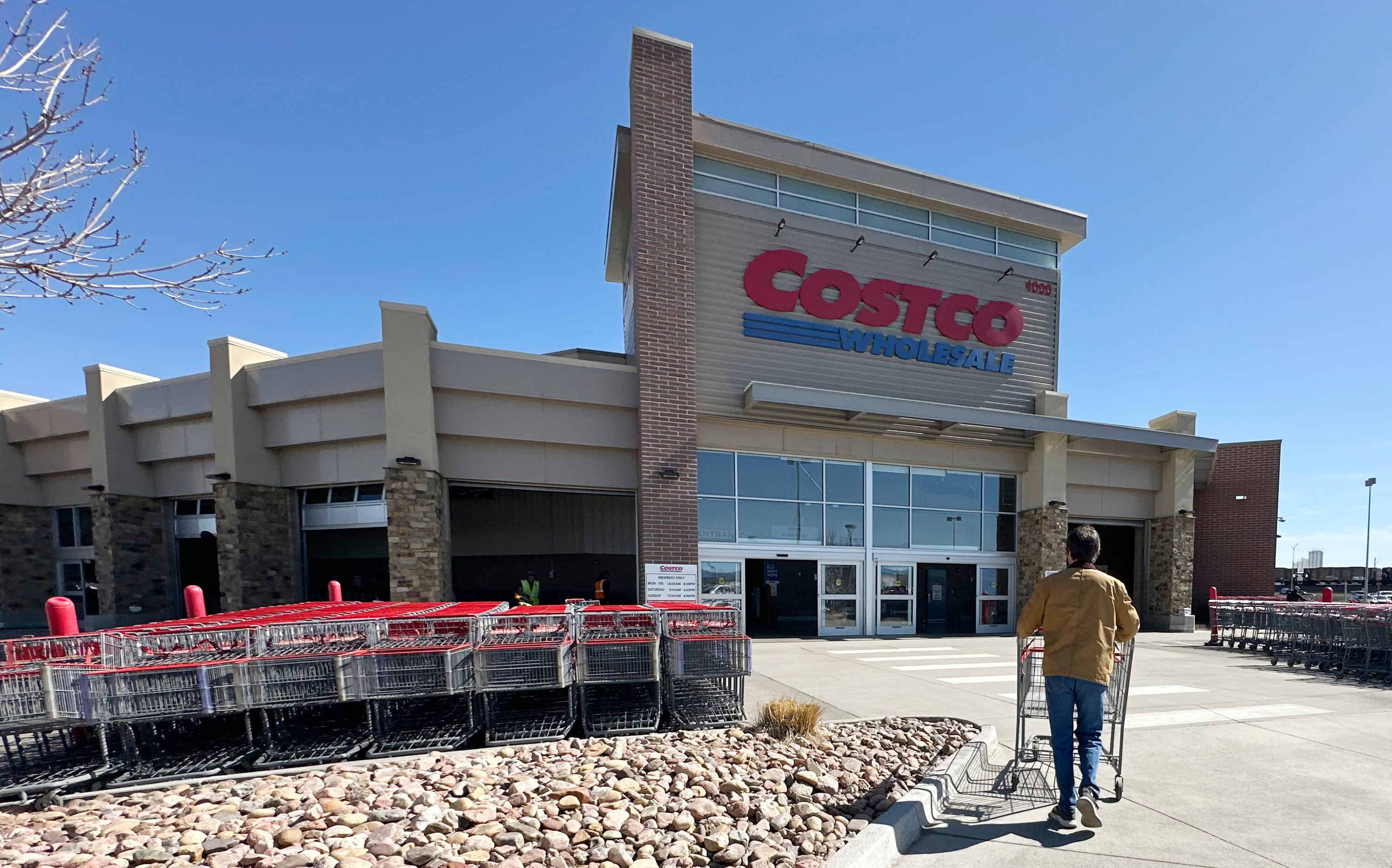 A shopper pushes a cart toward the entrance of a Costco warehouse, March 13, 2025, in Sheridan, Colo.