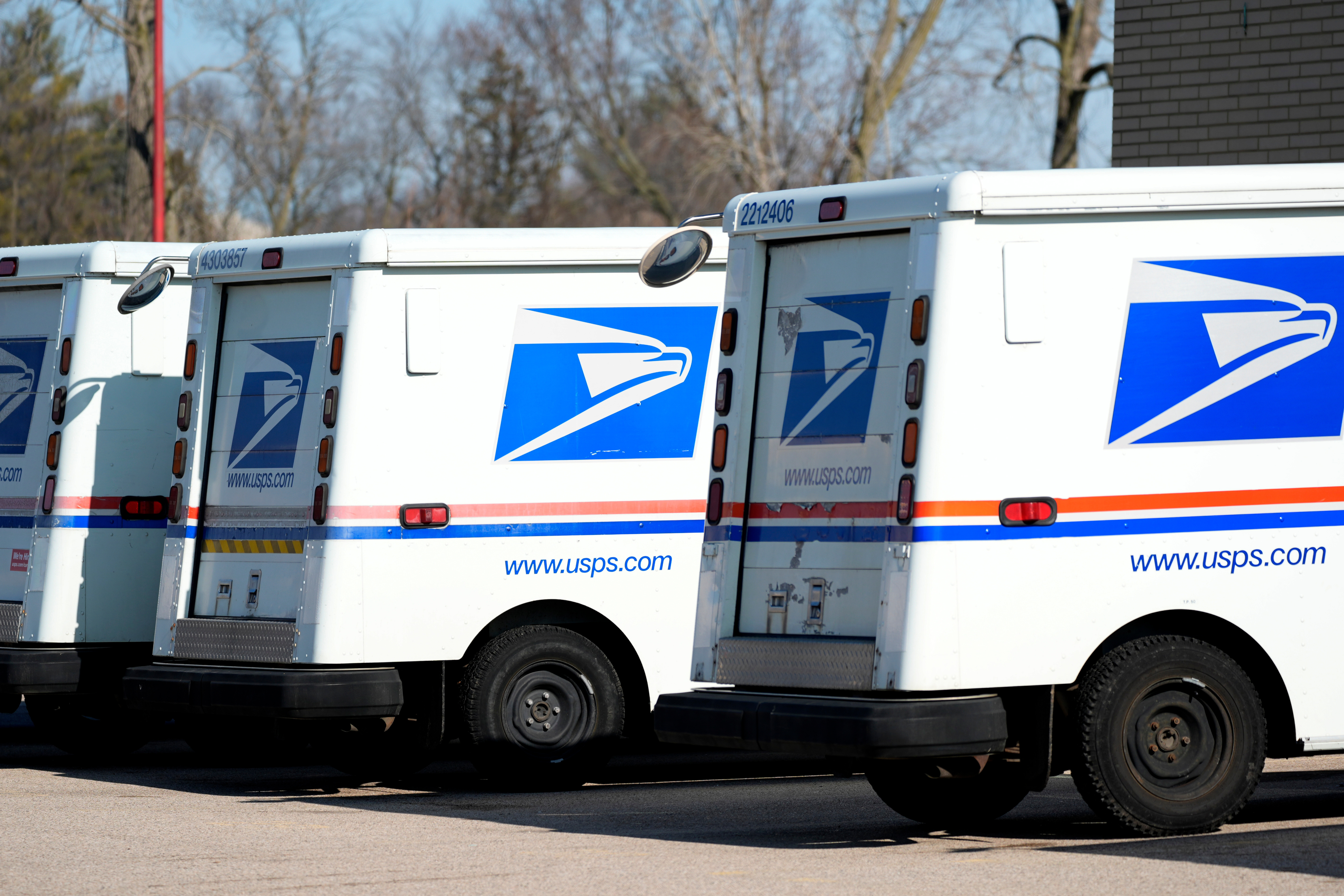 U.S. Postal Service trucks outside a post office, Jan. 29, 2024, Wheeling, Ill.