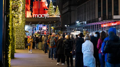 Shoppers wait in line to enter Macy's flagship store on Friday, Nov. 28, 2025.