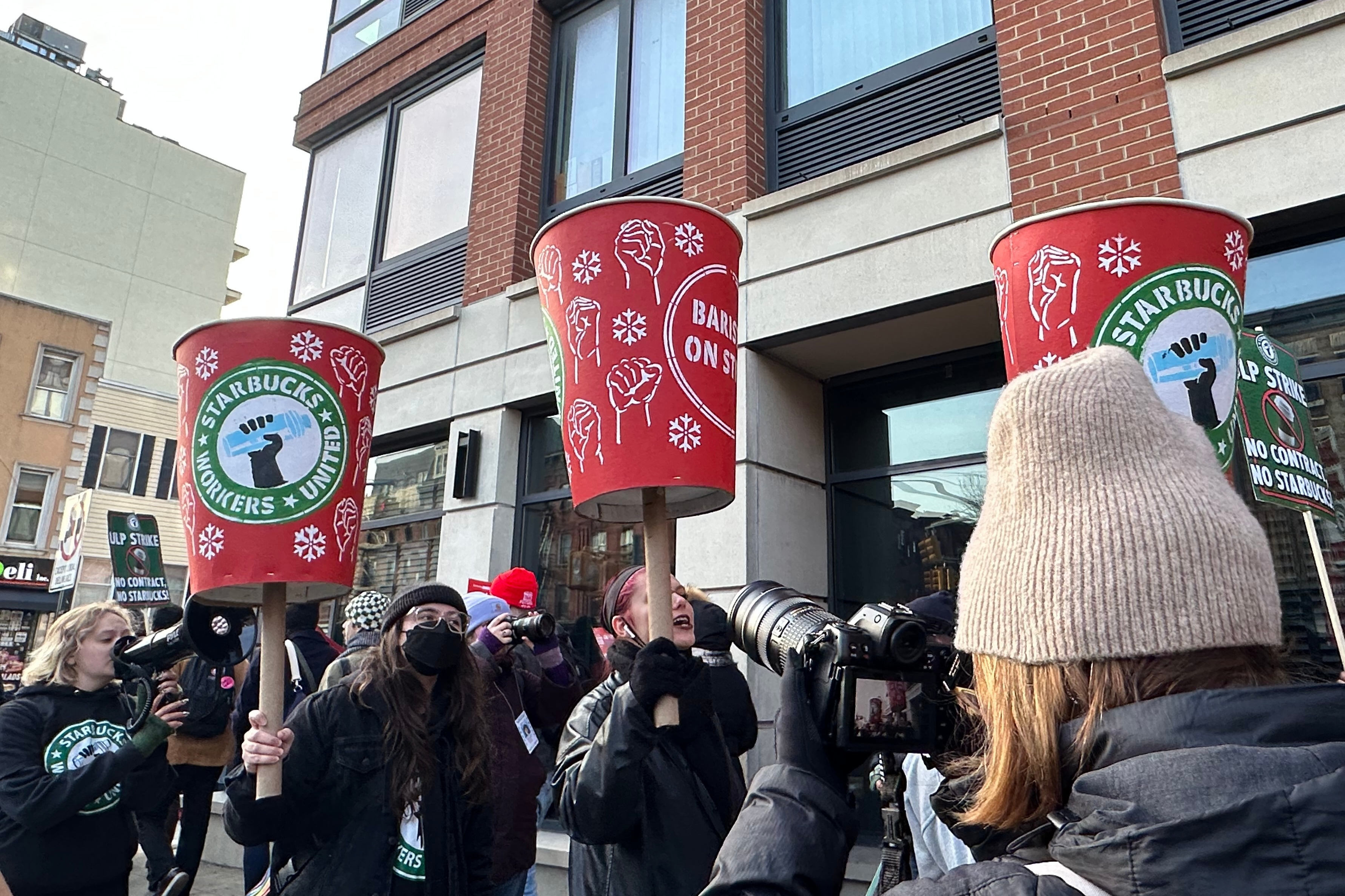 Starbucks employees and supporters picket outside a Starbucks store in the Brooklyn borough of New York, Monday, Dec. 1, 2025