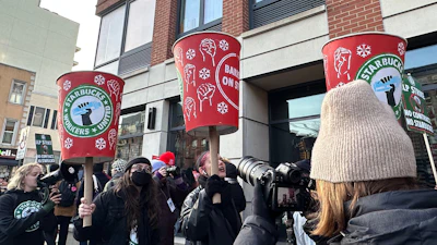 Starbucks employees and supporters picket outside a Starbucks store in the Brooklyn borough of New York, Monday, Dec. 1, 2025