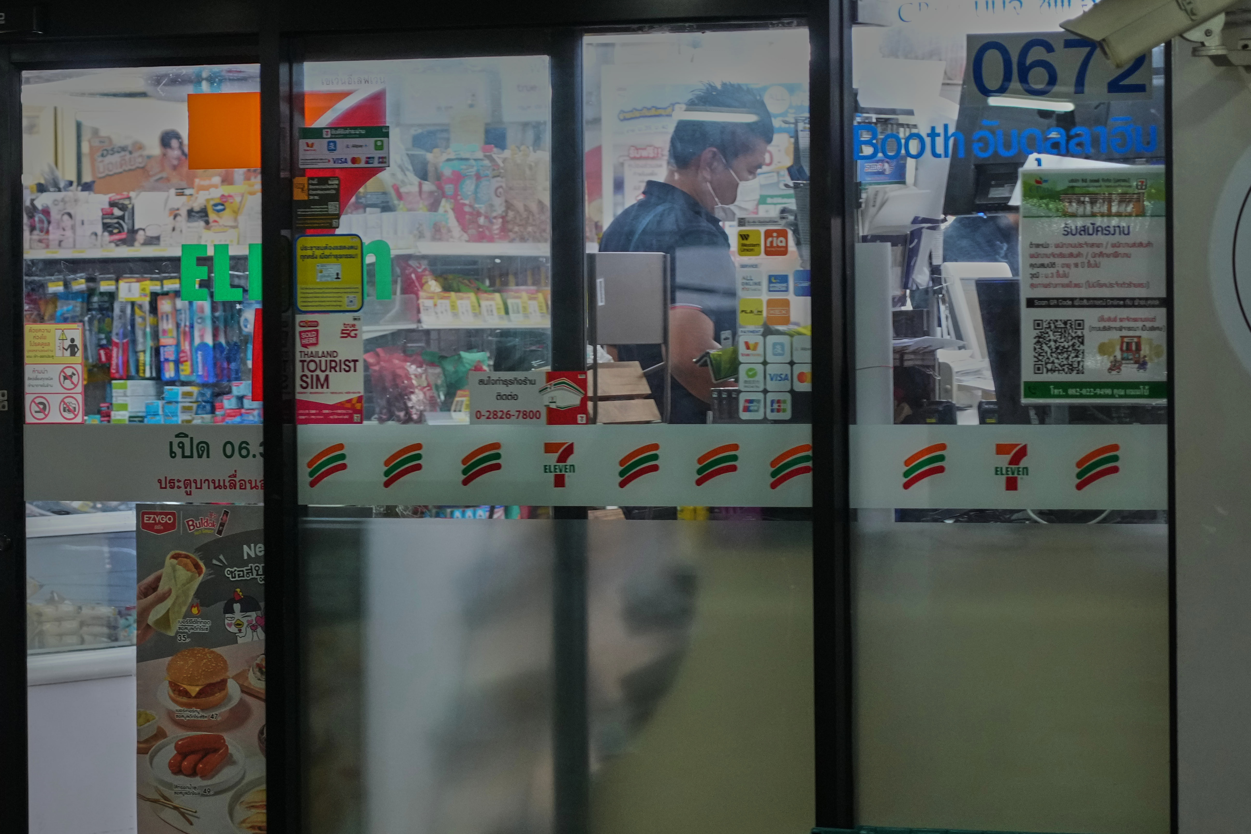 A customer lines up to pay at a convenience store in Bangkok, Dec. 3, 2025.
