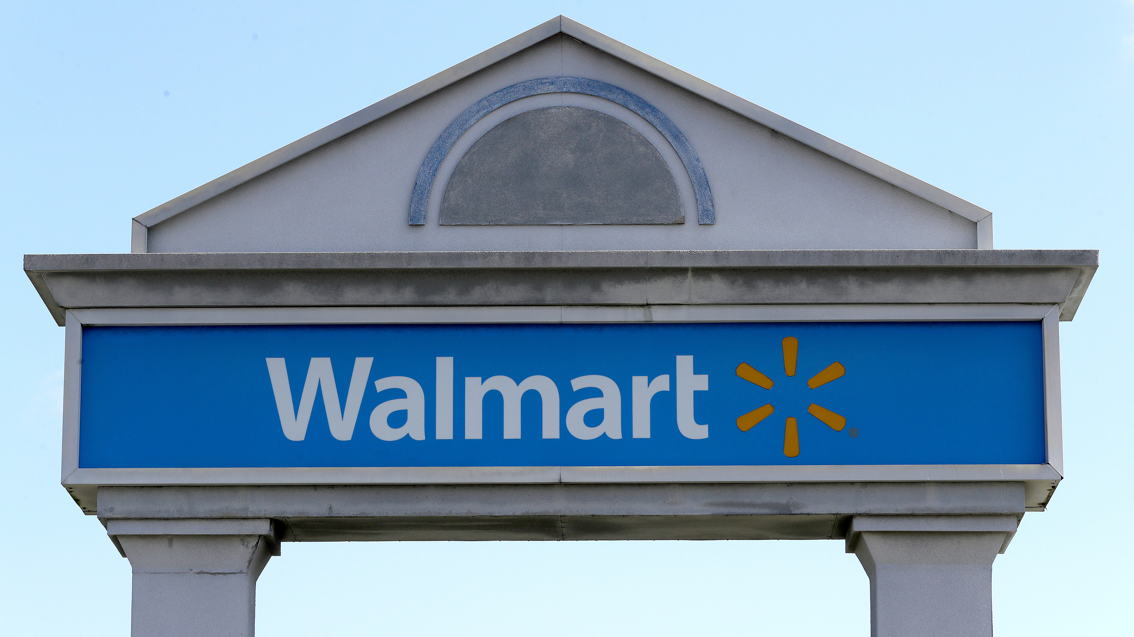 In this Tuesday, Sept. 3, 2019, file photo, a Walmart logo forms part of a sign outside a Walmart store, in Walpole, Mass.