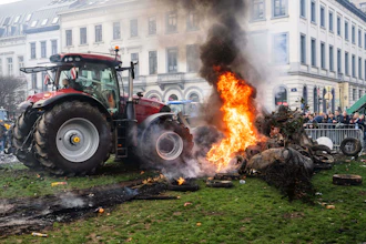 Protestors burn tires during a demonstration of European farmers outside the EU Summit meeting in Brussels, Dec. 18, 2025.