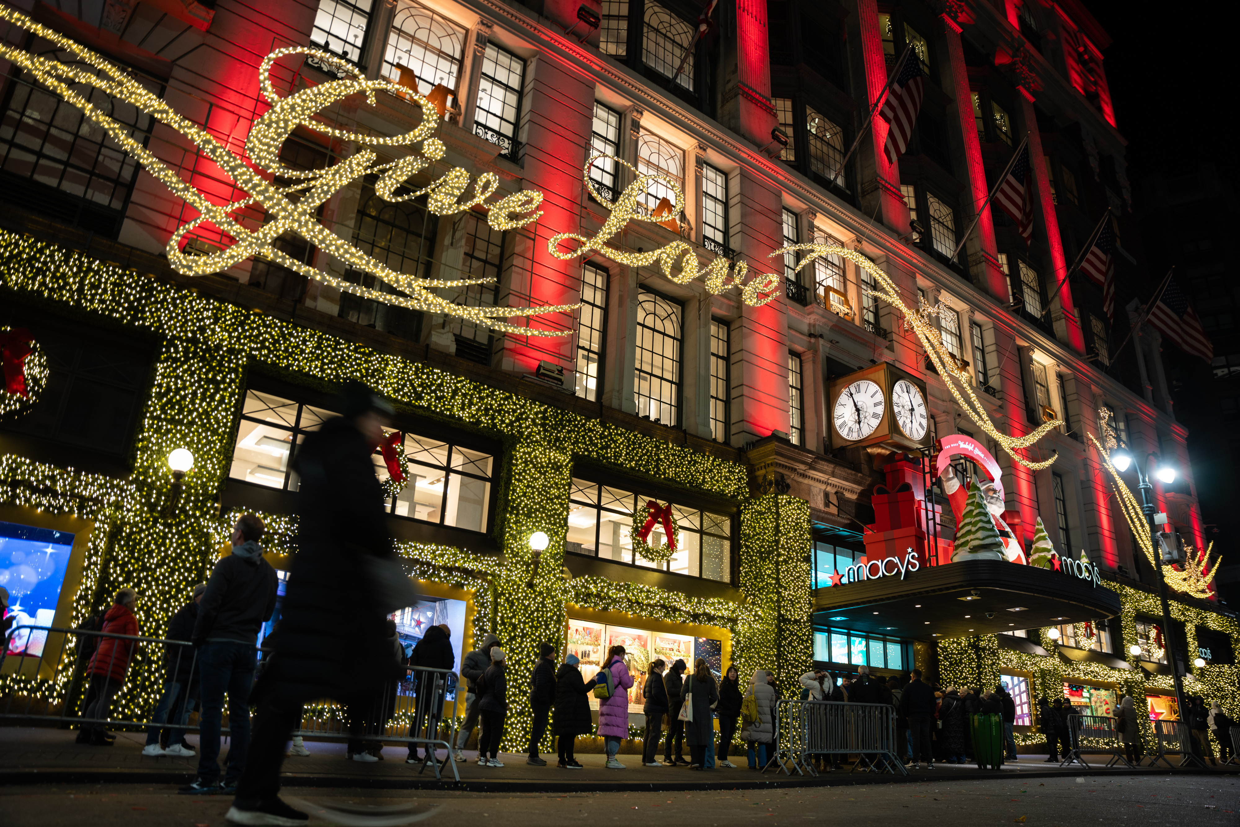 Shoppers wait in line to enter Macy's flagship store, Nov. 28, 2025, New York.