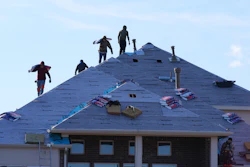 Roofers work atop a house in Anna, Texas, Dec. 18, 2025.