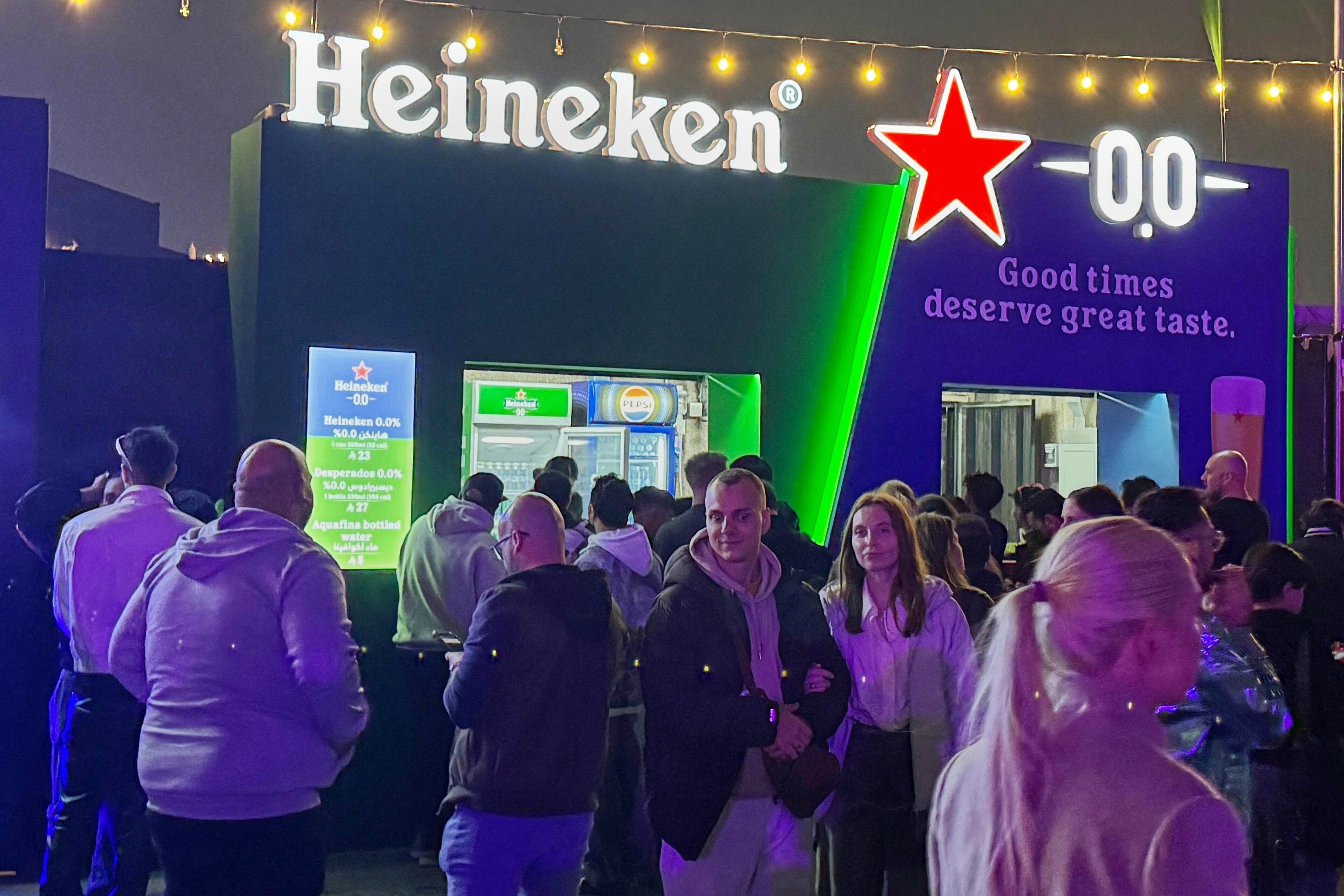 Festivalgoers gather near food and beverage stands, including a booth serving nonalcoholic beer, during the Soundstorm music festival in Riyadh, Saudi Arabia, Dec. 11, 2025.