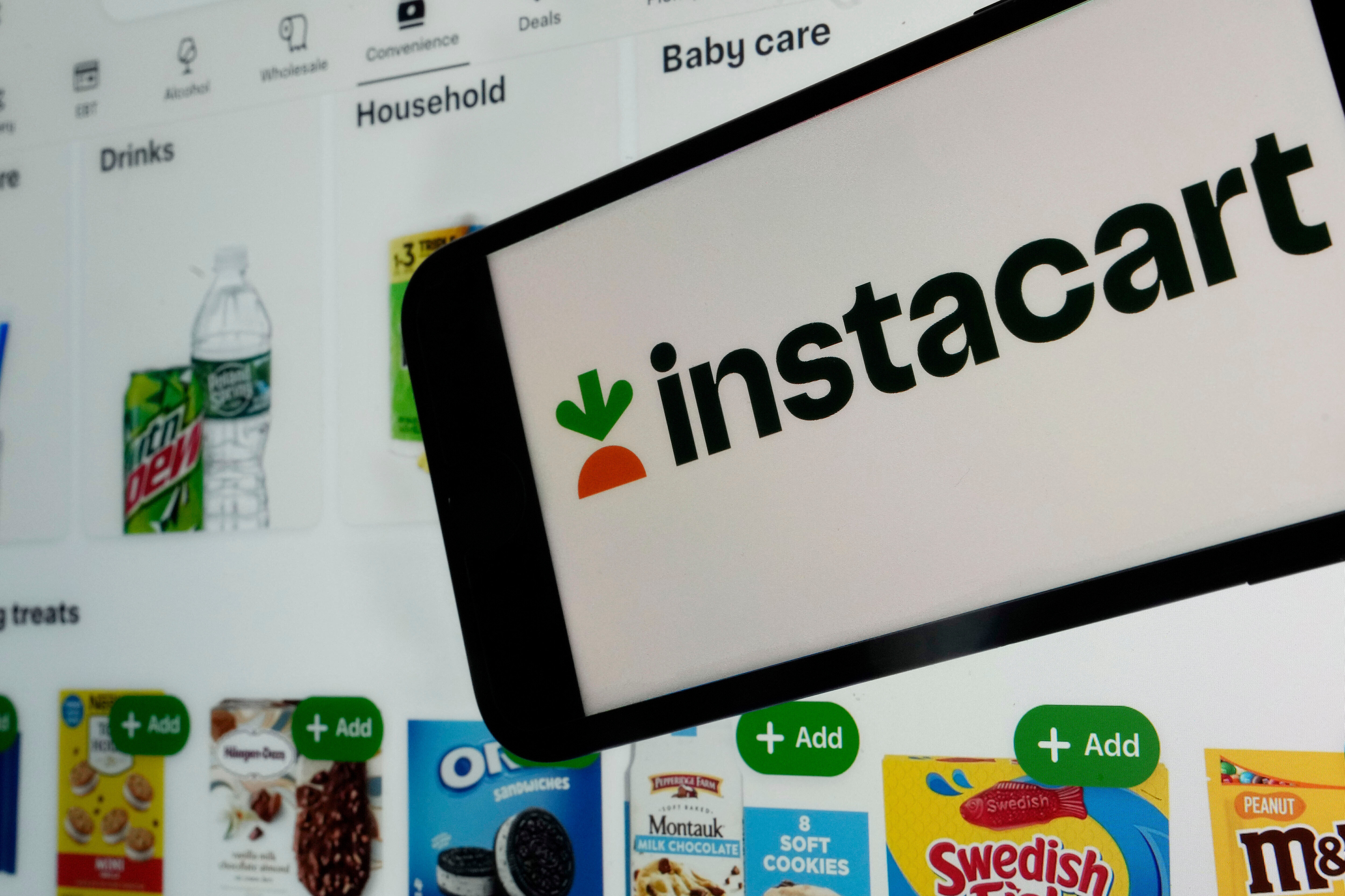 An instacart logo and an instacart webpage are seen in New York, Sept. 6, 2023.