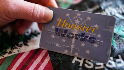 Dianna Tompkins holds a SNAP card at home in Demotte, Ind., Dec. 17, 2025.