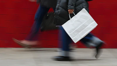 A person carries a shopping bag in Philadelphia, Dec. 10, 2025.