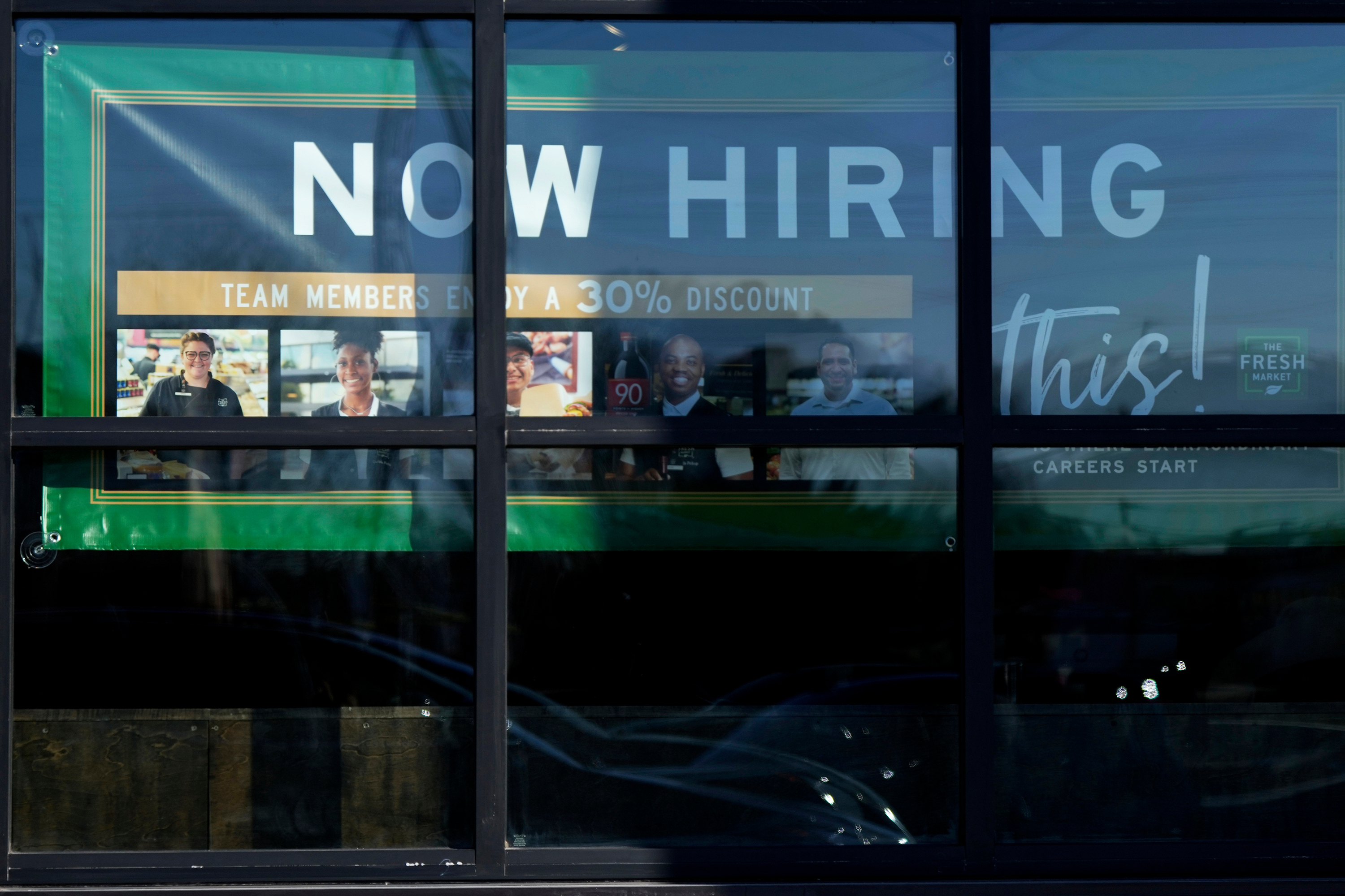 A hiring sign is displayed at a grocery store in Northbrook, Ill., Jan. 21, 2025.