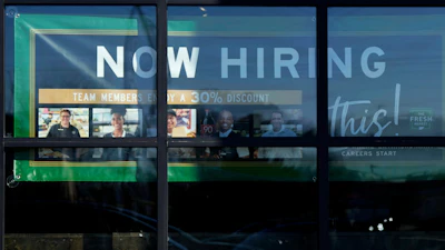 A hiring sign is displayed at a grocery store in Northbrook, Ill., Jan. 21, 2025.