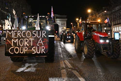 Farmers drive their tractors down the Champs-Elysees avenue in Paris, Jan. 13, 2026.