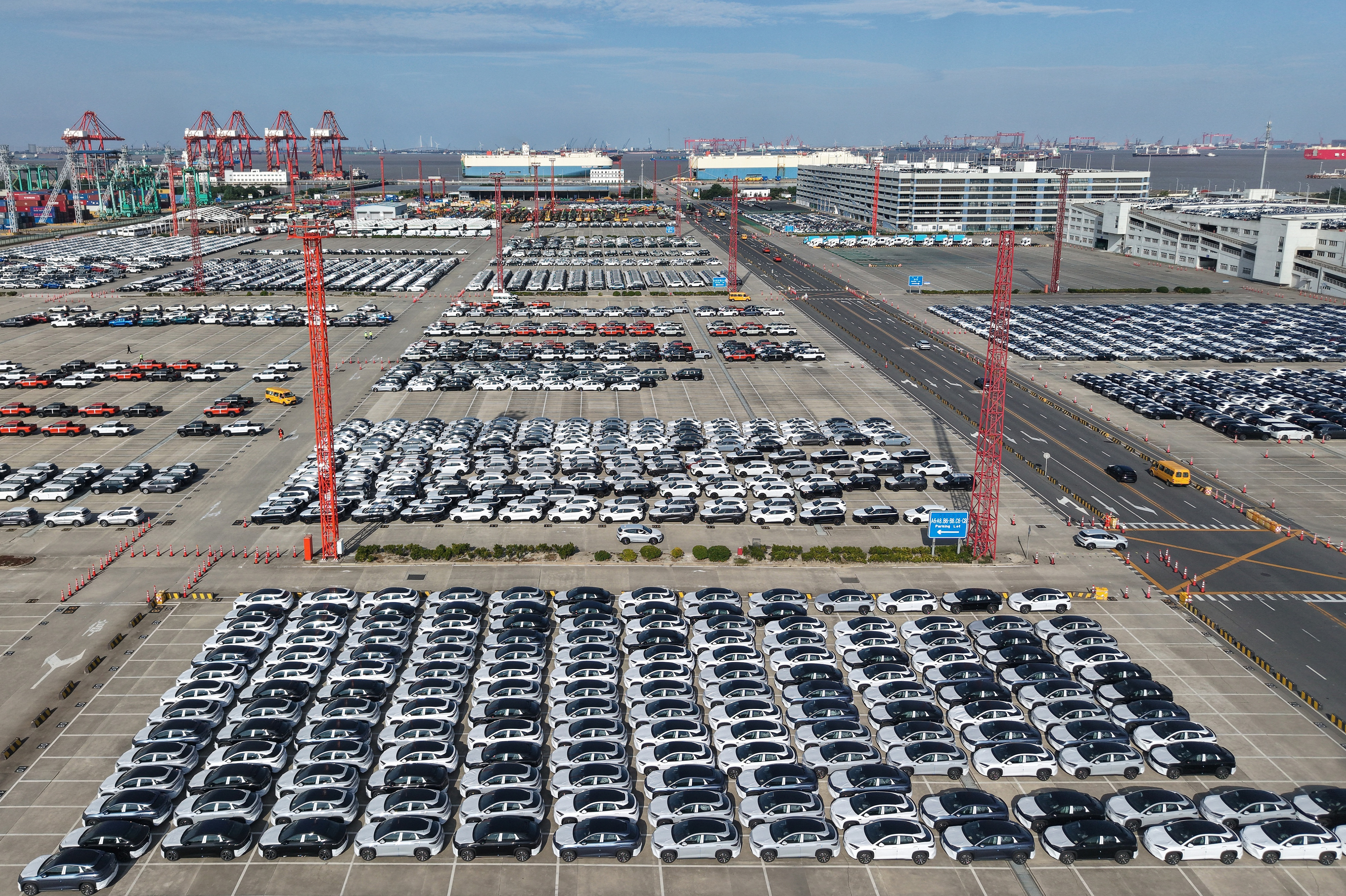 Aerial view of new cars waiting for shipment at a port in Shanghai, Jan. 14, 2026.