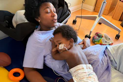In this photo provided by the family, Ashaan Carter lies on his mother, Angel Carter, at a children's hospital in Portland, Ore., in November 2025.