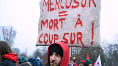 A man holds up a sign outside the European Parliament in Strasbourg, France, Jan. 20, 2026.