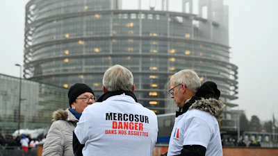 A protestor wears a shirt which reads 'Mercosur-danger on our dinner plate' outside the European Parliament in Strasbourg, France, Jan. 20, 2026.