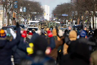 Protesters advance toward federal agents with their hands up near the site of the fatal shooting of 37-year-old Alex Pretti by federal agents in Minneapolis, Jan. 24, 2026.
