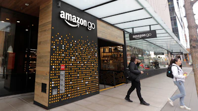 People walk out of an Amazon Go store in Seattle, March 4, 2020.