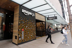 People walk out of an Amazon Go store in Seattle, March 4, 2020.