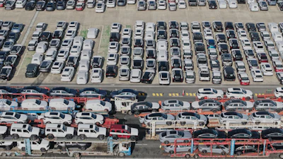 Aerial view of new cars waiting for shipment at a port in Shanghai, Jan. 14, 2026.