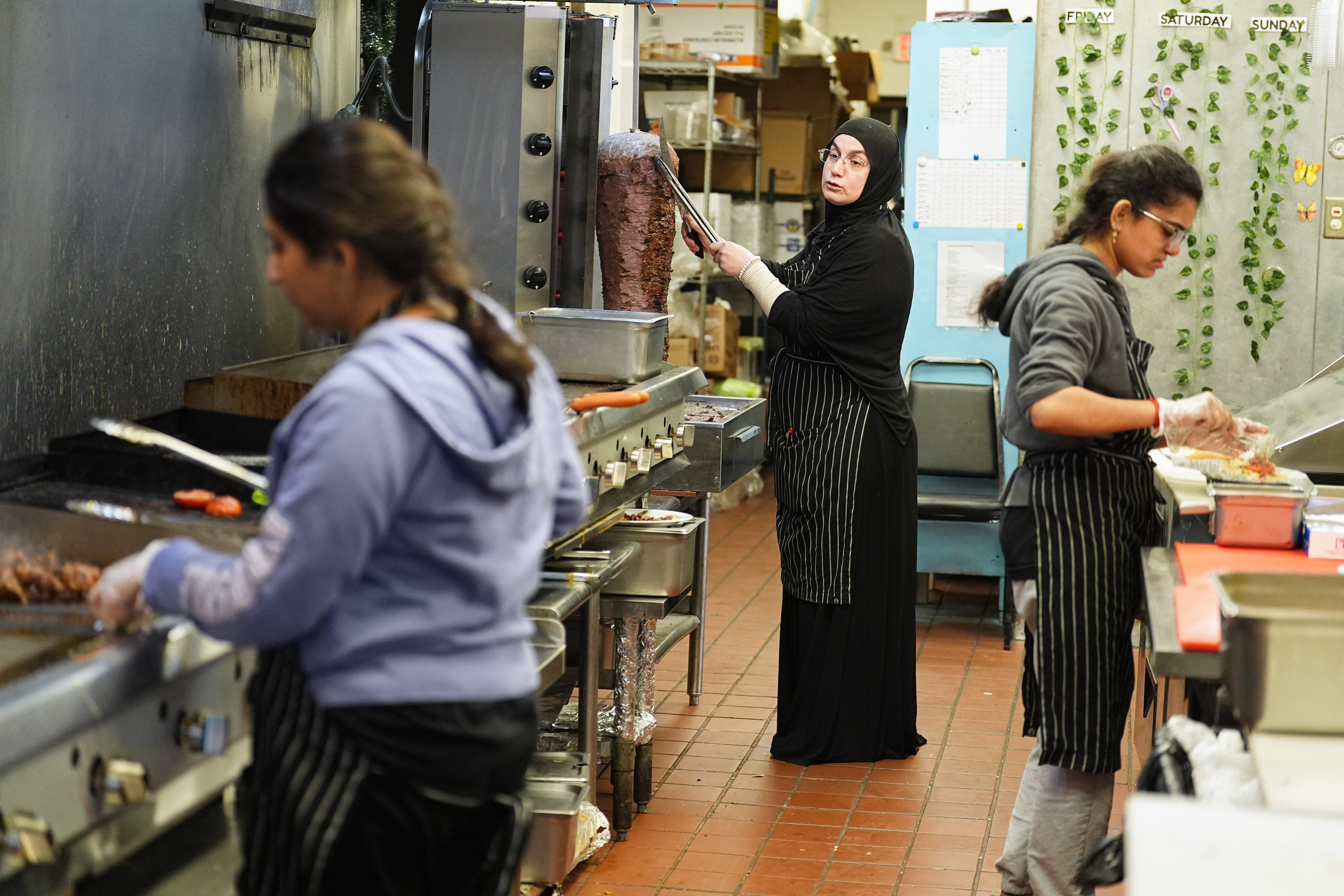 Emine Emanet, center, prepares food in the kitchen at the Jersey Kebab restaurant, Jan. 29, 2026, Collingswood, N.J.
