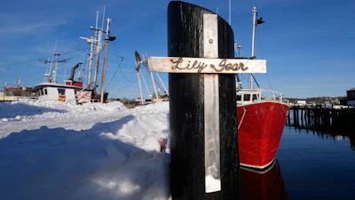 A crucifix, made by a friend of the captain of the fishing boat 'Lily Jean,' is displayed on a pier in Gloucester, Mass., Feb. 2, 2026.